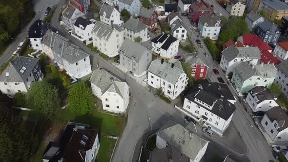 Top down view over Bergen Laksevaag and Damsgaard neighborhood - tilting up to reveal city with fjor alt