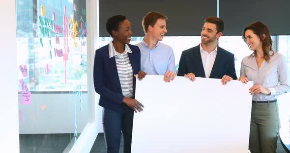 Portrait of business colleagues holding a blank banner 4k alt