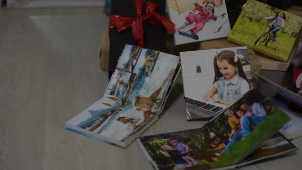 Photobooks Near the New Year Tree Colored As a Gift for the Holiday