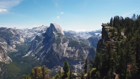 Drone captures a mountain landscape over a cliff at Glacier Point, Yosemite, California, USA alt