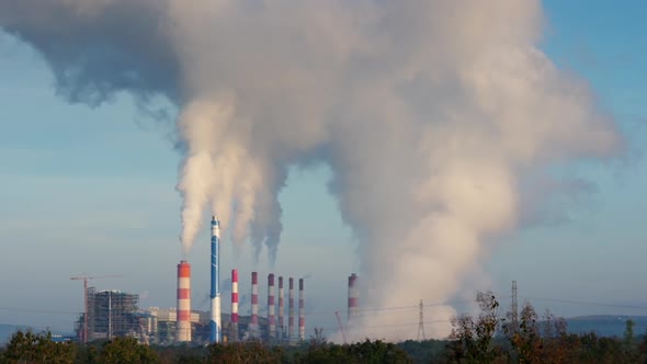 Coal-fired power plants that steam into the atmosphere from the chimney.