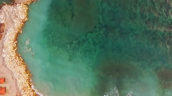 Aerial View of a Rocky Beach Coast Line and Huge Waves on Bali alt