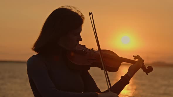 Woman Violinist Is Playing On Sunrise