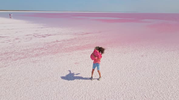 Aerial View of Happy Romantic Couple Walking Hands to Hands and Kissing alt