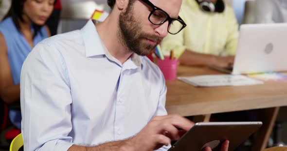 Male business executive using digital tablet alt