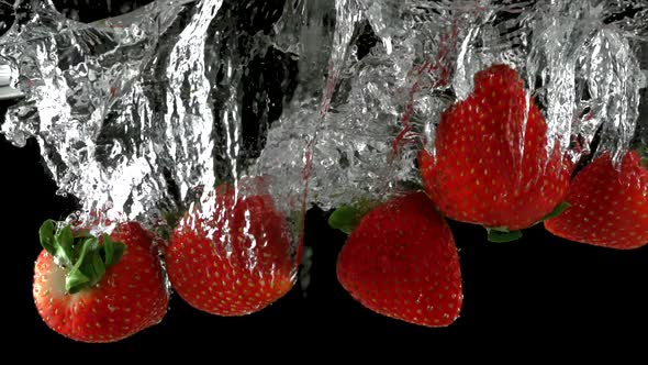 Slo-motion strawberry through water alt