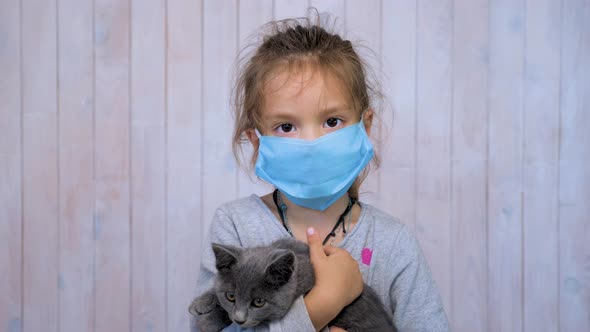 Stay at Home in Quarantine, Kid with Kitten During COVID-19 Coronavirus Pandemic. Little Girl in