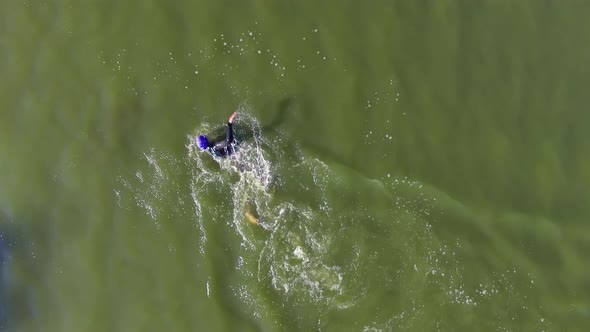 Woman Is Swimrunning in Lake During Triathlon Training Outdoors