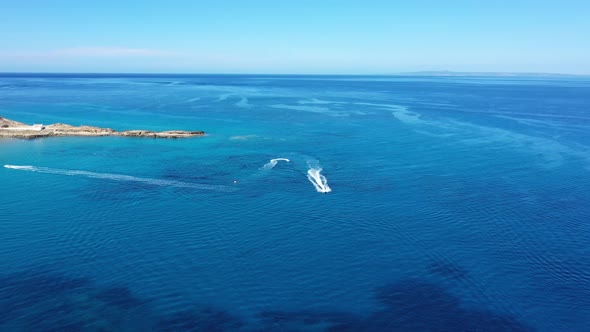 Aerial View of a Motor Boat Towing a Tube. Zakynthos, Greece