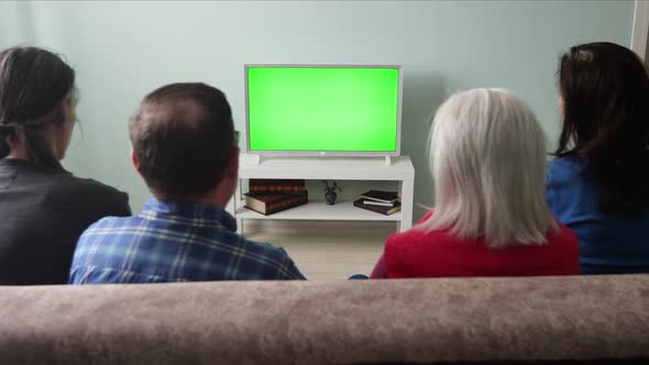 Family Watching TV. Green Screen.