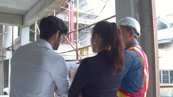 home owner couple with site manager engineer architect discuss consult and inspection constructure alt