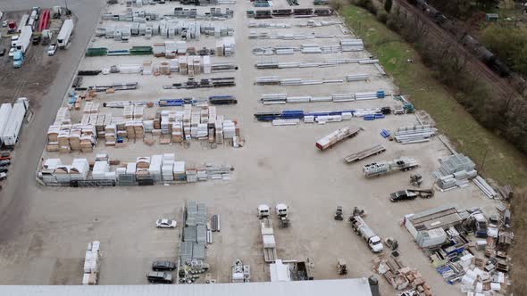 Aerial Drone View of Truck Repair Shop Service Building and Many Trucks Near It alt