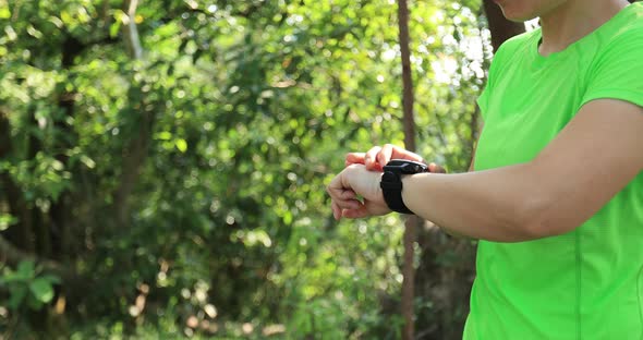Woman trail runner running in tropical forest mountain alt