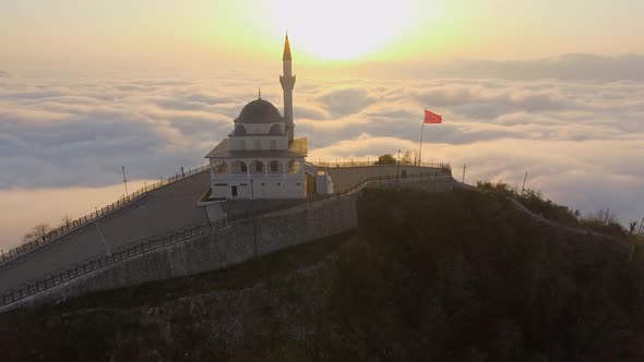 Rising from Behind the Place of Worship Above the Clouds alt
