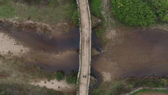 Drone aerial top above view of an ancient historic stone bridge in Idanha a velha, Portugal alt