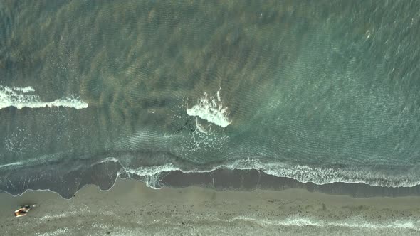 Cinematic aerial drone footage of waves crashing on the shore