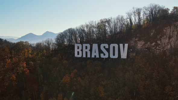 Brasov sign on the top of the hill near the city, yellowed trees, Romania alt