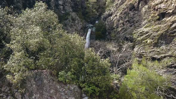 Camera Is Flying Over Mountains Peak and Showing Amazing Waterfall, Aerial