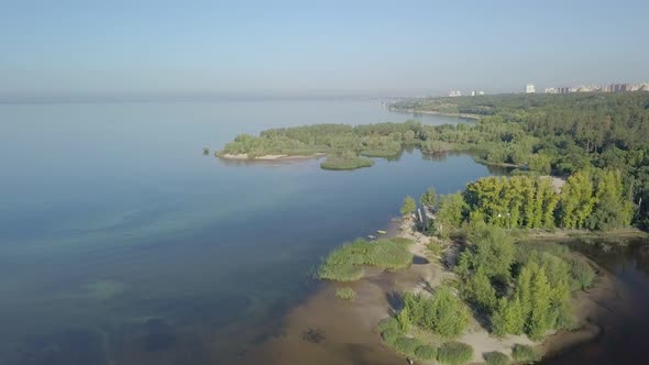Aerial View on Calm Landscape with Lakes, River, City Panorama in Background