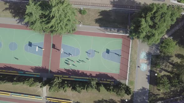  Aerial view children playing football on sports ground. Summer vacation holidays Sport team games
