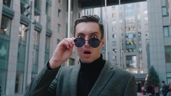 Shocked Young Businessman Takes Off His Sunglasses Surprise alt