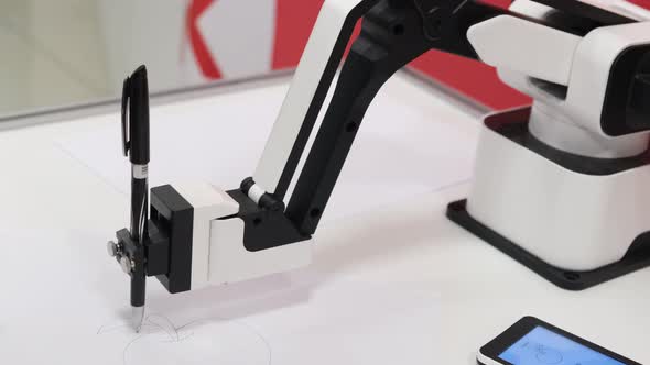 A Modern Robot Draws a Picture with a Ballpoint Pen alt