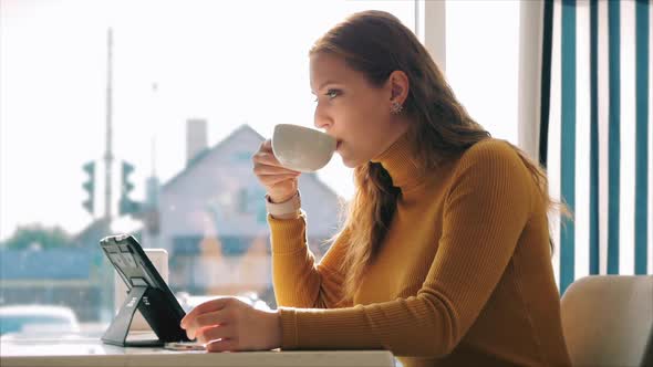 Beautiful Sunny Day Young Woman Drinks Morning Coffee in a Cafe, Making Online a Purchase Easy alt