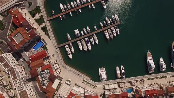 Drone View of Marina Village Buildings Next to the Yacht Pier in Lustica Bay alt