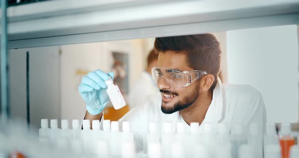 Young Smiling Student in White Coat Doing Chemical Tasks