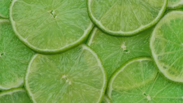 Rotating Background of Lime Slices Closeup Fresh Summer Bright Background