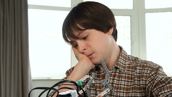 Little Boy Discourages By Toy Vehicle Assembling alt