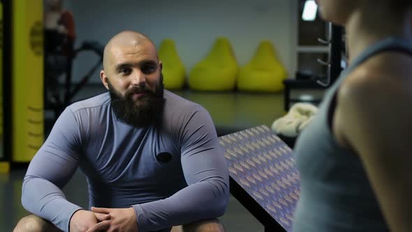 Handsome Sportive Man Talking to Young Woman in Gym, Casual Acquaintance, Flirt alt