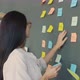 Creative Young Woman Working with Sticky Notes Sticking Colorful Stickers on Office Wall - VideoHive Item for Sale