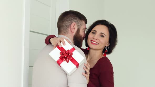 Husband hugs wife makes surprise.