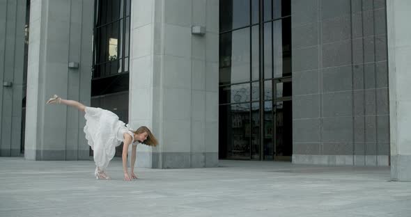 Young Dancer in White Dress Does Leg Swing in Slow Motion Outdoors Balerina Dances in the Gallery of alt