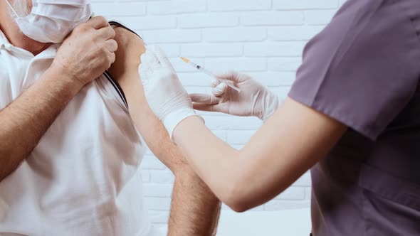 Nurse Making Light Massage After Inoculation alt