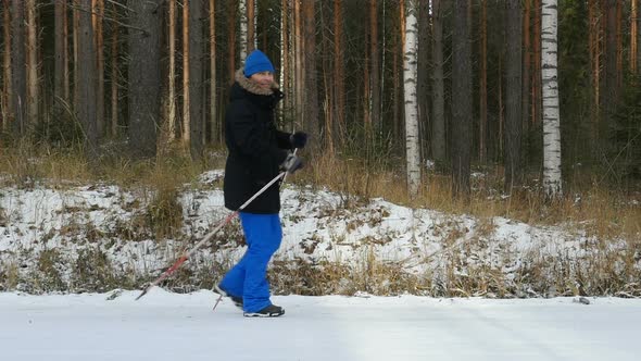 Young Man Does Sport, Fitness, Nordic Walking And Exercising Outdoors, Winter Forest, Countryside. M