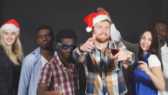 Young Mixed Race Friends Dancing at Christmas Party in Studio.