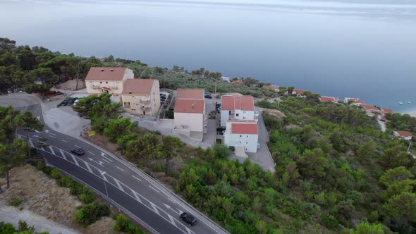 Drone Panoramic View of the Houses on the Mountain Near the Highway at the Sea Coast