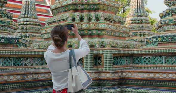 Woman take photo on cellphone at Thailand temple