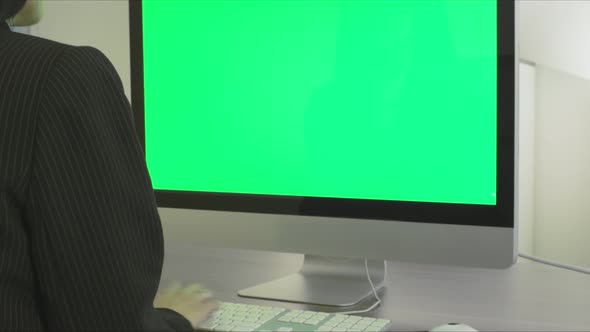 Woman In Office Using Computer Green Screen