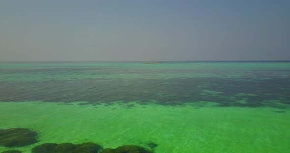 Wide angle drone abstract view of a sunshine white sandy paradise beach and blue ocean background in alt