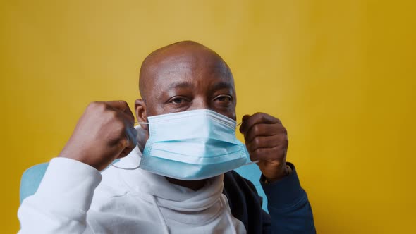 AfricanAmerican Man Wears a Blue Medical Mask on His Face