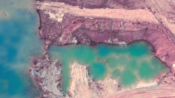 Lake with Blue Water in a Sandyclay Quarry  Clouds are Reflected in the Water  Aerial Shot alt