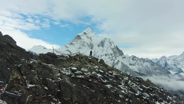Hiker Man Looking on Ama Dablam Mountain. Himalaya, Nepal. Aerial View alt