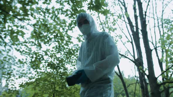 Criminalists Taking Pictures at Crime Scene in Forest Using Professional Photo Camera Taking alt