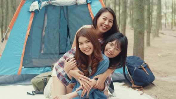 Group of young asia camper friends camping near relax enjoy moment in forest.