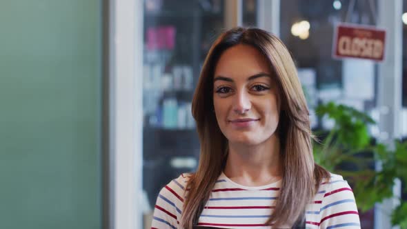 Portrait of Female hairdresser smiling at hair salon alt