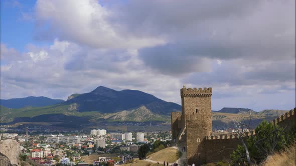 Mountains in the Blue Sky with White Clouds. The City Is Located in the Valley. Crowds of Tourists alt