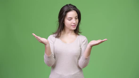 Young Happy Beautiful Woman Choosing Between Left and Right alt